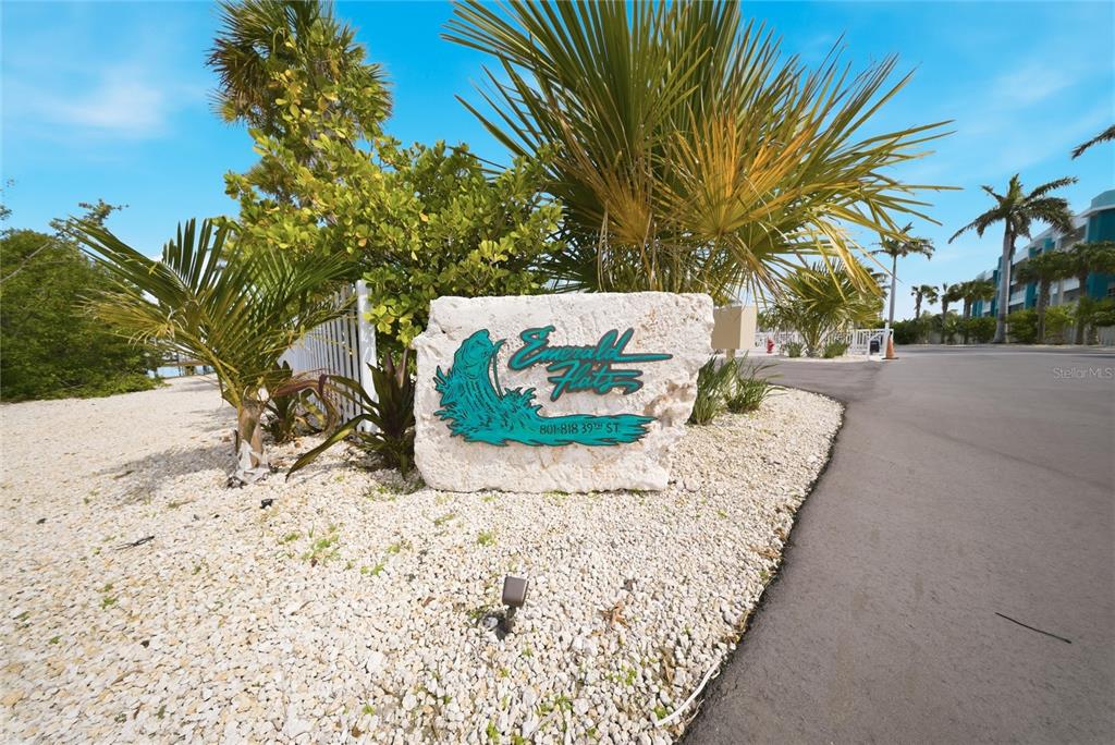 A sandy beach area features several palm trees overlooking the ocean near a white house — 805 39TH STREET GULF, MARATHON, FL