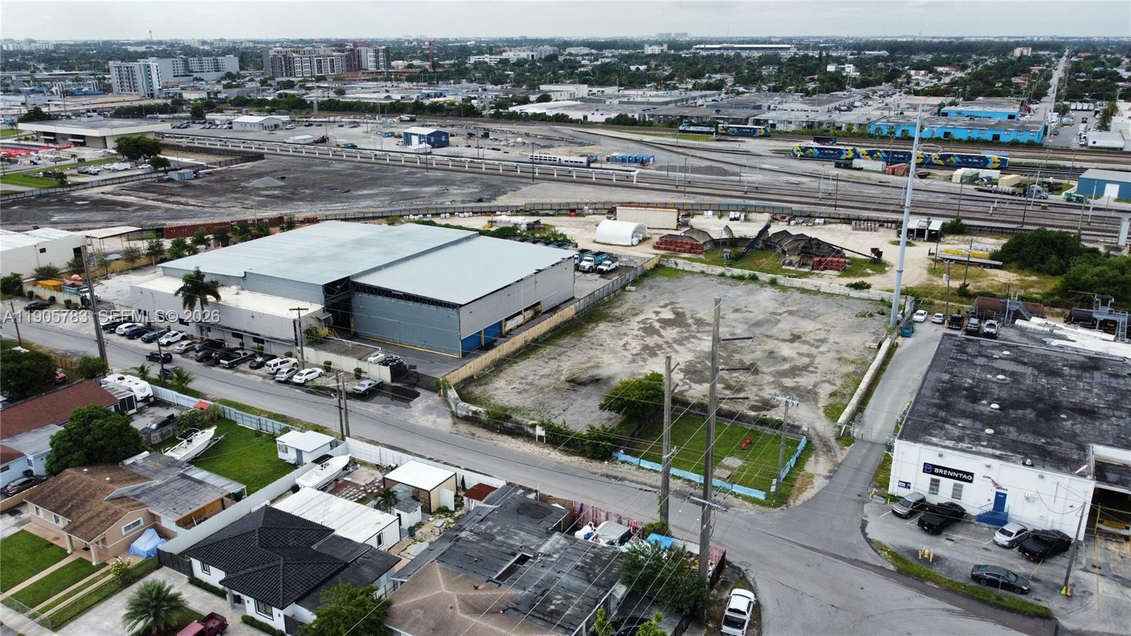 An aerial view shows a large warehouse, an adjacent vacant lot, and nearby industrial buildings — 8600 NW 36th Ave, Miami FL 33147, MIAMI, FL