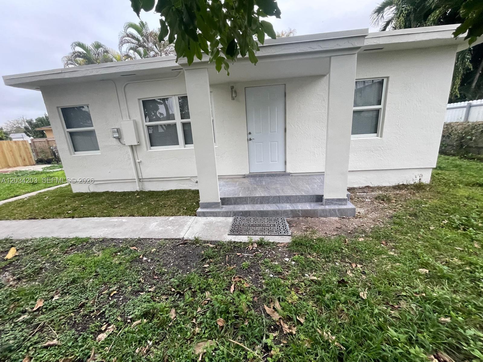 A white, single-story house features a covered front porch with gray tiled steps — 2103 SW 60th Ave # 2, Miami FL 33155, MIAMI, FL
