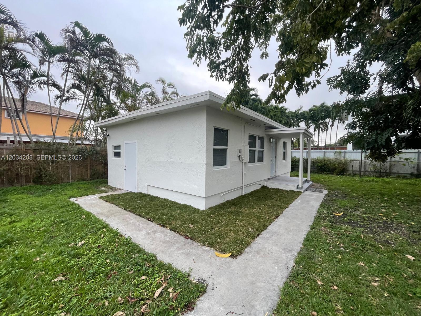 A small, white, flat-roofed detached building sits on a grassy lot with concrete walkways — 2103 SW 60th Ave # 2, Miami FL 33155, MIAMI, FL