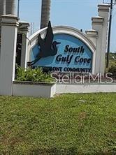 A sign for the South Gulf Cove waterfront community stands in a grassy area — 15490 MEACHAM CIRCLE, PORT CHARLOTTE, FL