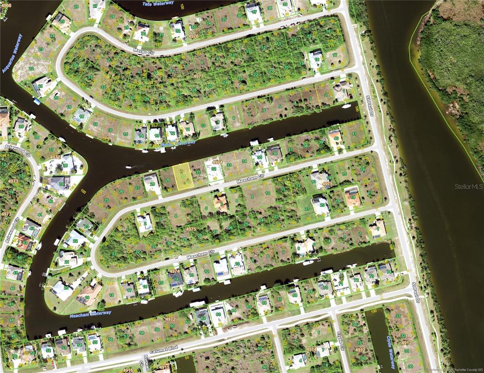 This is an aerial map showing residential lots and waterways in a suburban neighborhood — 15490 MEACHAM CIRCLE, PORT CHARLOTTE, FL