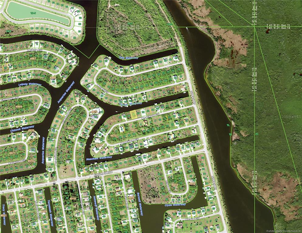 This is an aerial map showing residential lots and waterways in a suburban neighborhood — 15490 MEACHAM CIRCLE, PORT CHARLOTTE, FL