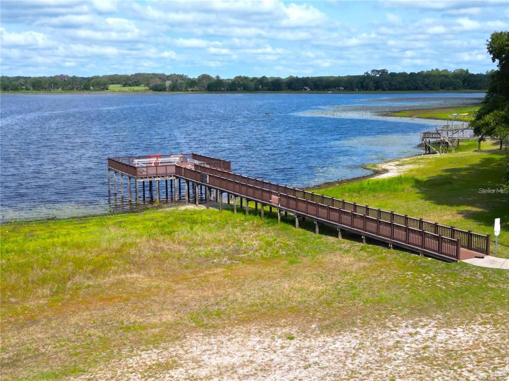 An elevated view of a long wooden dock extending into a large lake — LOT 21 SW RAINBOW LAKES BOULEVARD, DUNNELLON, FL