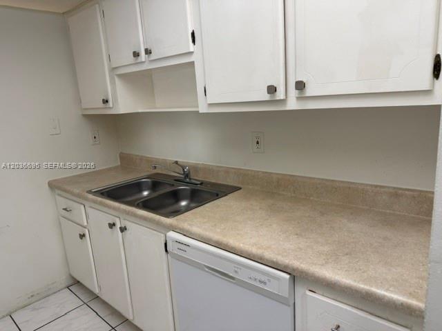 A kitchen features white cabinets, a double-basin sink, and a beige laminate countertop — 14221 N Kendall Dr # 211C, Miami FL 33186, MIAMI, FL