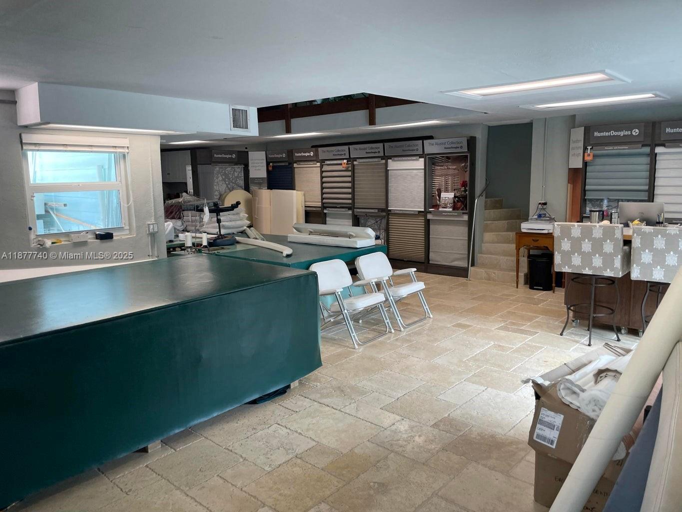 A commercial showroom features large work tables, Hunter Douglas window treatment displays, and tile flooring — 108 Madeira Rd, Islamorada FL 33036, ISLAMORADA, FL