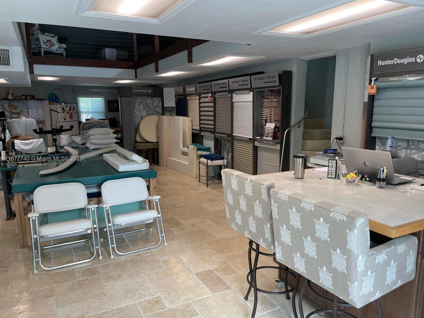 A commercial showroom features Hunter Douglas window treatment displays, tile flooring, and a central workspace — 108 Madeira Rd, Islamorada FL 33036, ISLAMORADA, FL