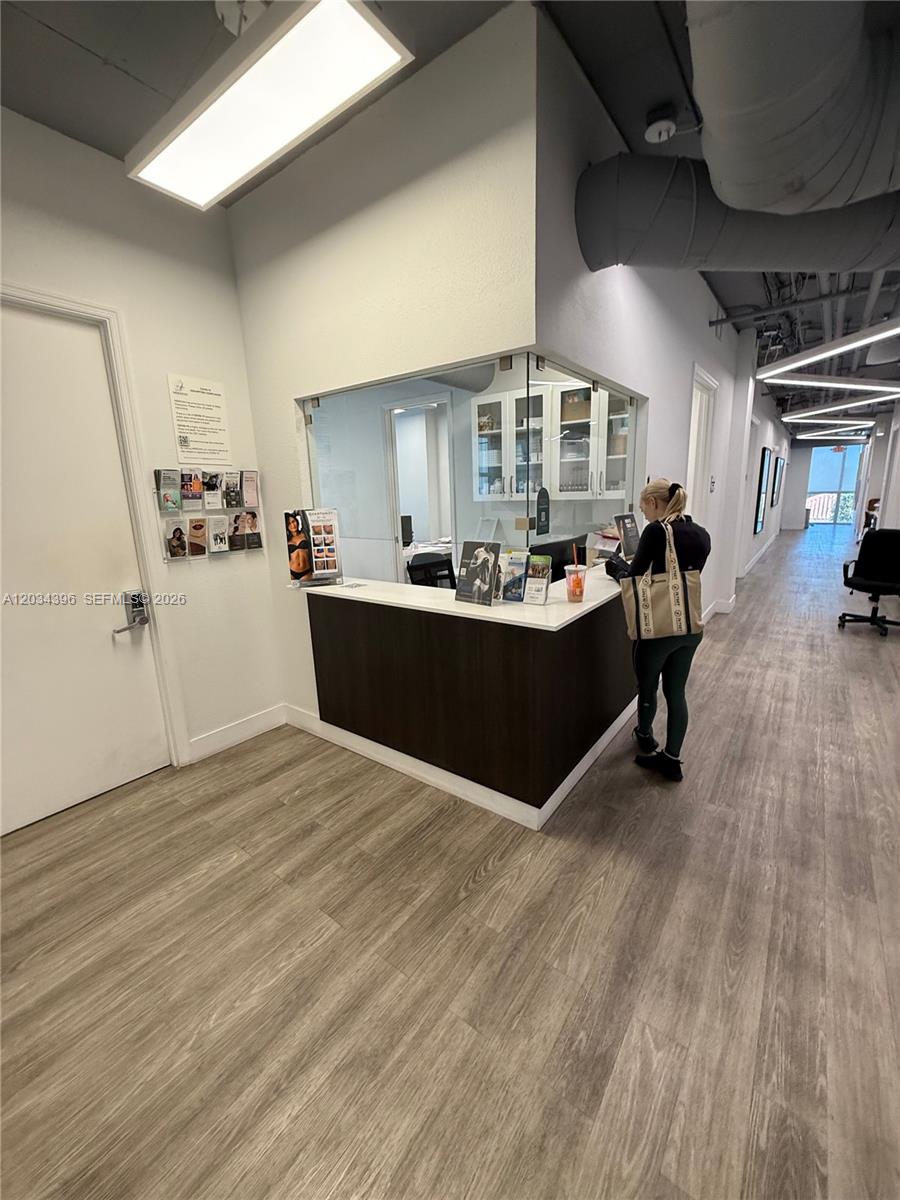 A reception desk with a glass partition stands in a modern office hallway — 2801 SW 3rd Ave, Miami FL 33129, MIAMI, FL