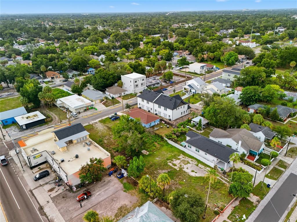 An aerial view shows a residential neighborhood with a mix of houses and commercial buildings — 2215 E COLUMBUS DRIVE, TAMPA, FL