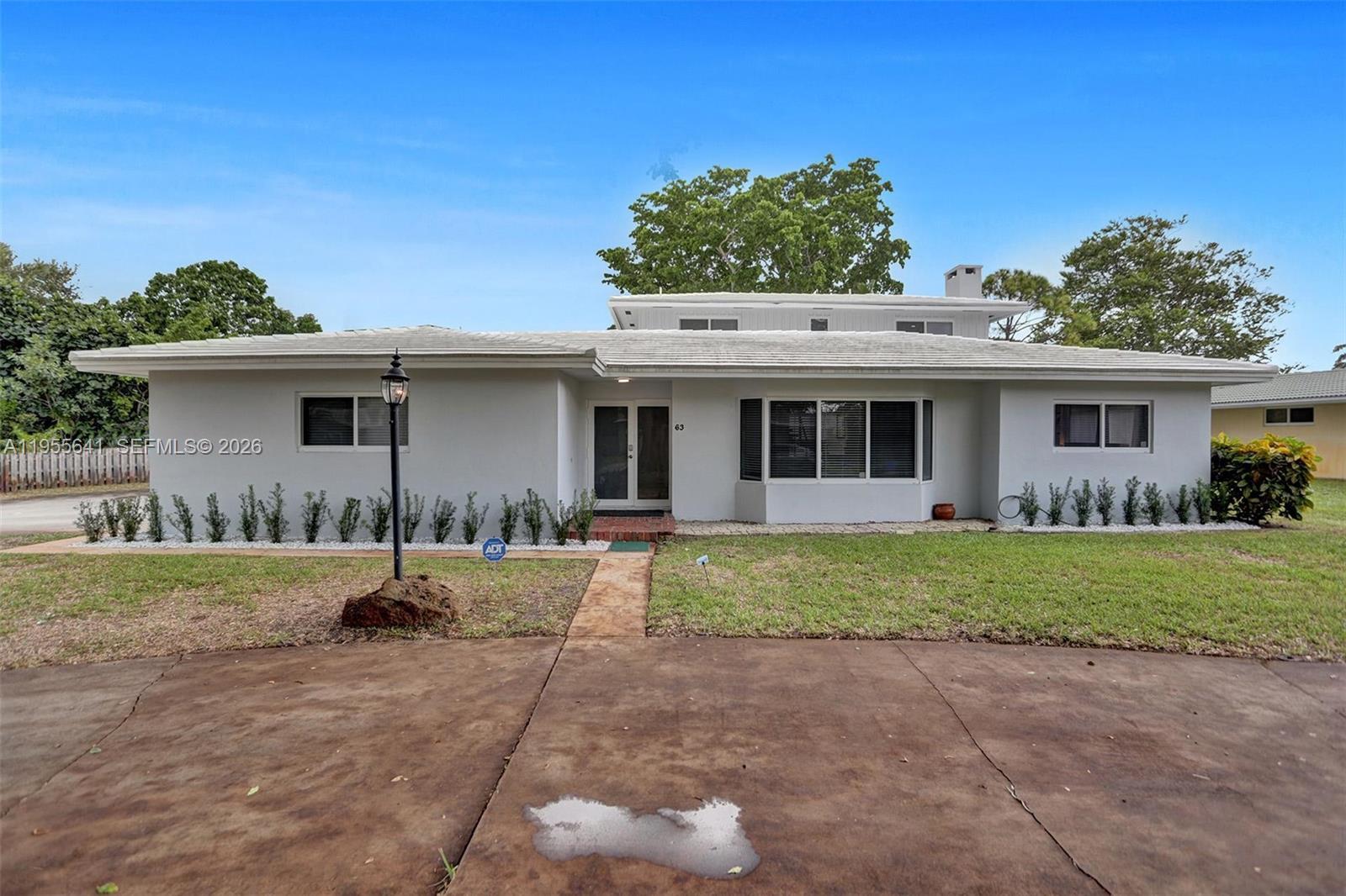A single-story house with a gray exterior, a white roof, and a paved driveway — 63 SE 5th Ave, Deerfield Beach FL 33441, DEERFIELD BEACH, FL