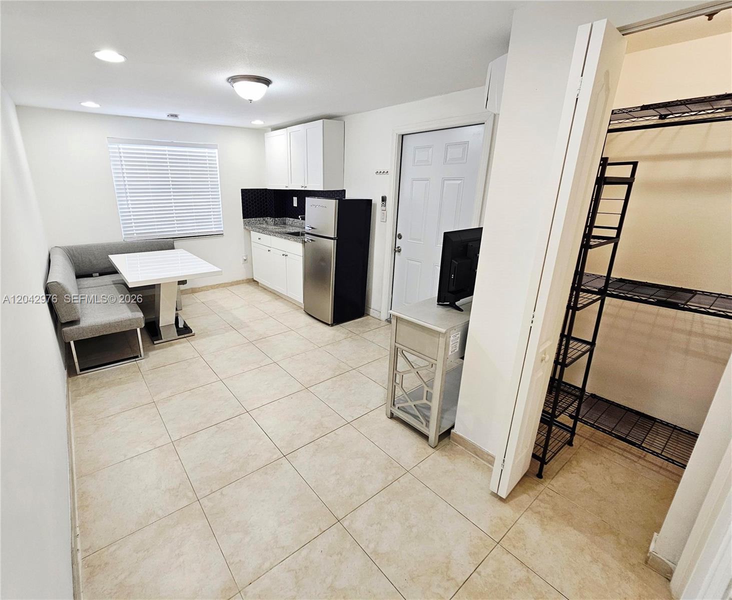 This studio apartment features a kitchenette, a dining nook, and a walk-in storage closet — 000 NW 51 AVE, Miami FL 33126, MIAMI, FL