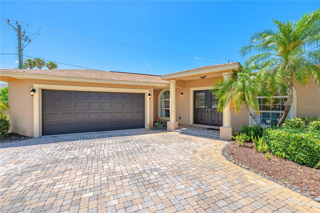 A single-story house with a paved driveway, a double garage, and a palm tree — 3524 S SCHOOL AVENUE, SARASOTA, FL