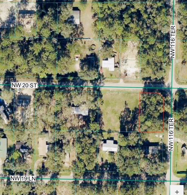 An aerial view shows a vacant, wooded lot outlined in red at a street intersection — TBD NW 20TH ST, OCALA, FL