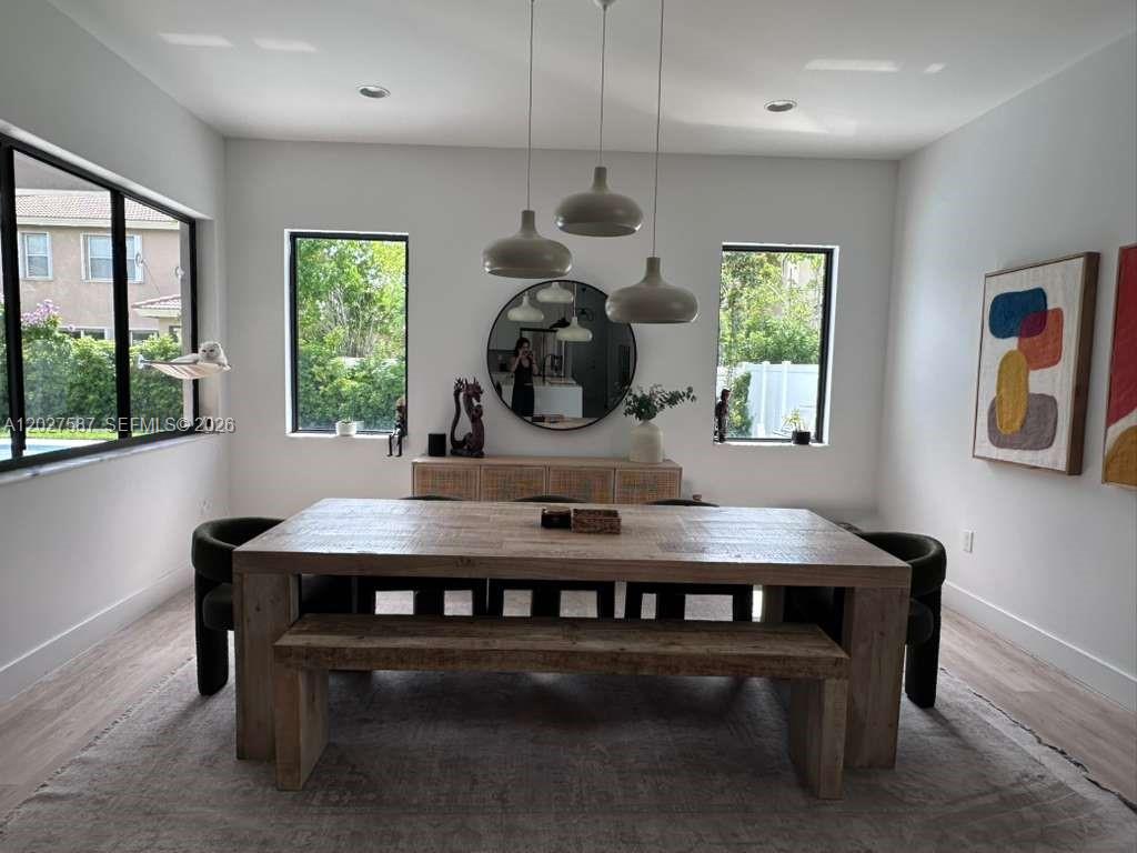 A dining room features a wooden table, bench, pendant lights, and a round wall mirror — 4572 SW 178th Ave, Miramar FL 33029, MIRAMAR, FL