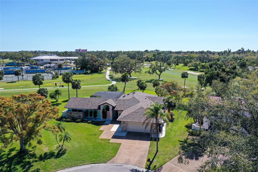 An aerial view of a single-story house with a shingled roof overlooking a golf course — 3704 PRAIRIE DUNES DRIVE, SARASOTA, FL