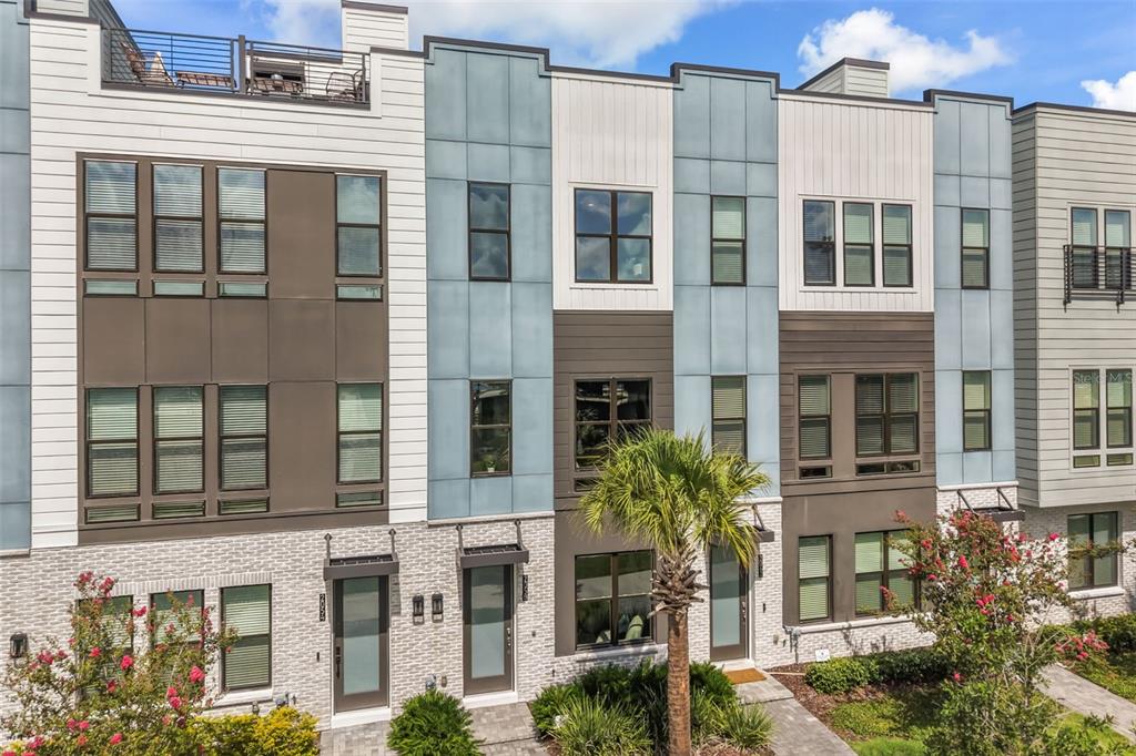 An aerial view shows multiple tennis courts next to a residential complex and a pond — 2058 PACKING DISTRICT WAY, ORLANDO, FL