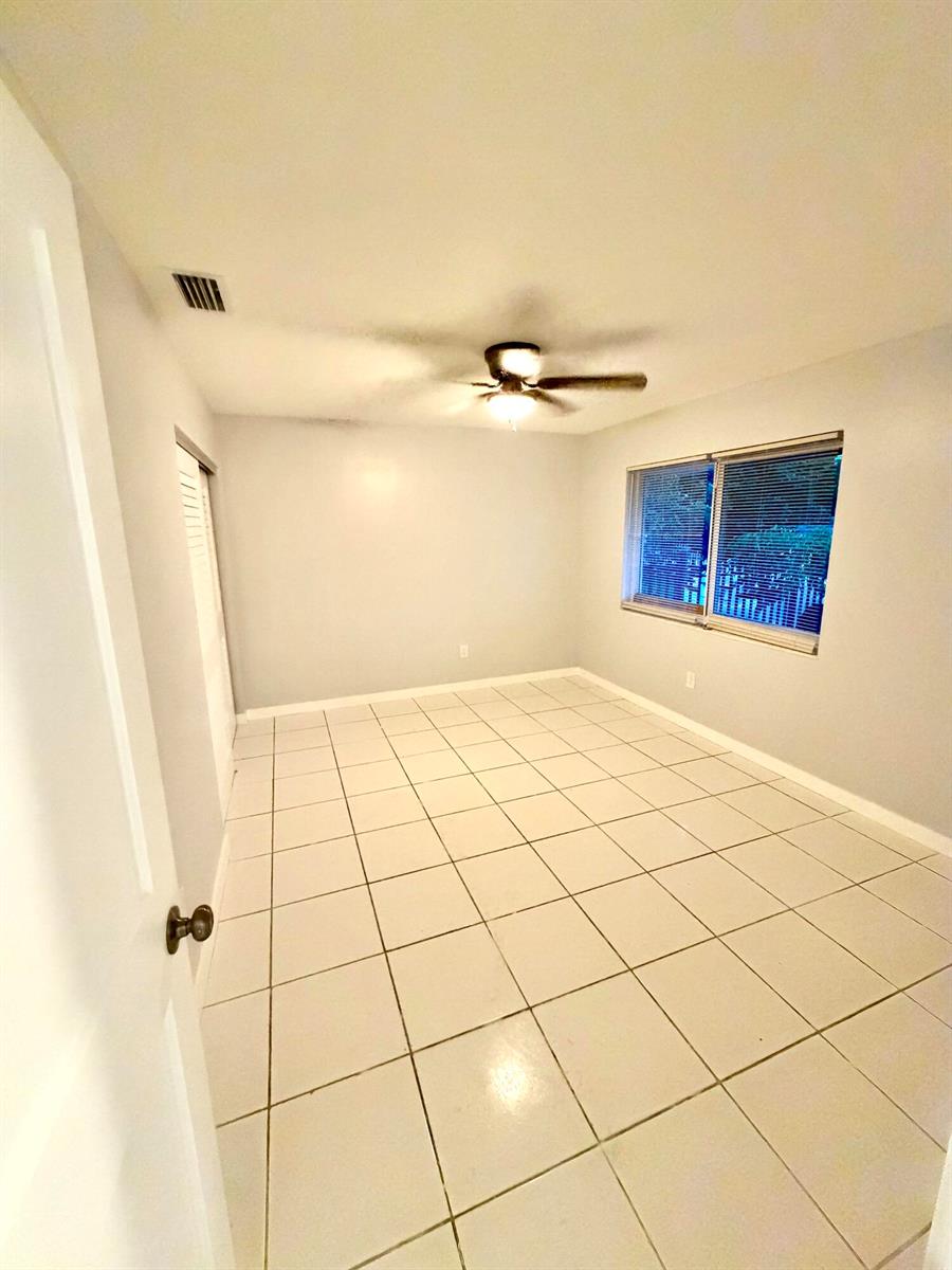An empty room features light gray walls, white tile flooring, and a ceiling fan — 2941 NW 195th Street, Miami Gardens FL 33056, MIAMI GARDENS, FL