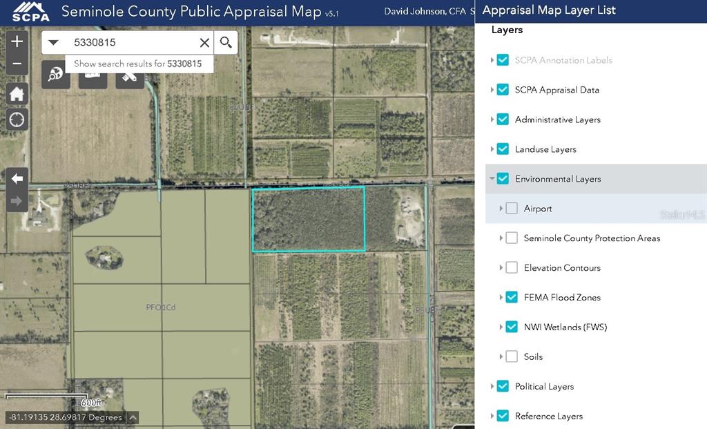 This is a digital map showing a highlighted parcel of land with environmental overlay layers — 601 HOWARD AVENUE, OVIEDO, FL