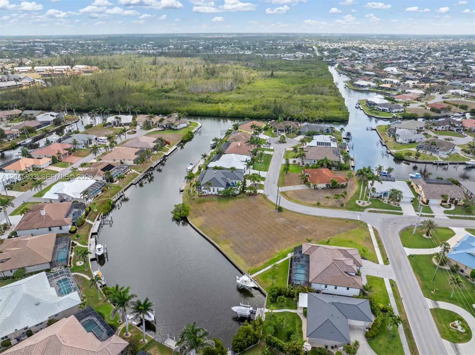 An aerial view shows waterfront homes with boat docks along a canal in Florida — 1466 Kiwi, Punta Gorda FL 33950, PUNTA GORDA, FL