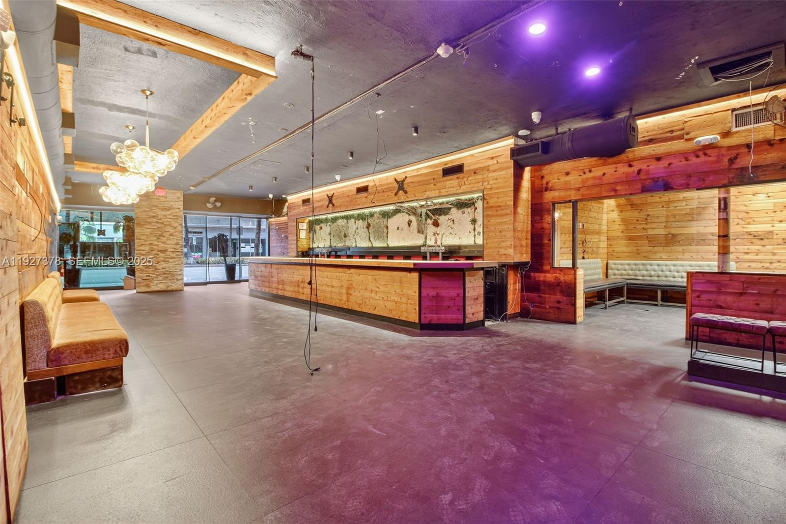 A commercial bar space features wood-paneled walls, a long service counter, and tile flooring — 1216 Washington AVE, Miami Beach FL 33139, MIAMI BEACH, FL