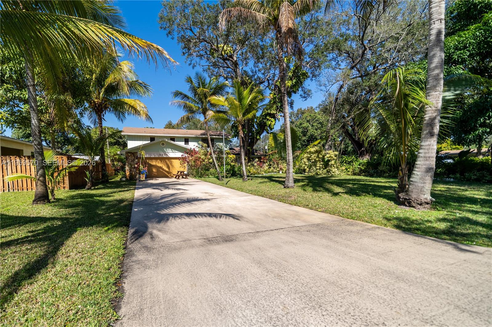 A two-story house with a concrete driveway and palm trees in the front yard — 6337 SW 32nd St, Miramar FL 33023, MIRAMAR, FL