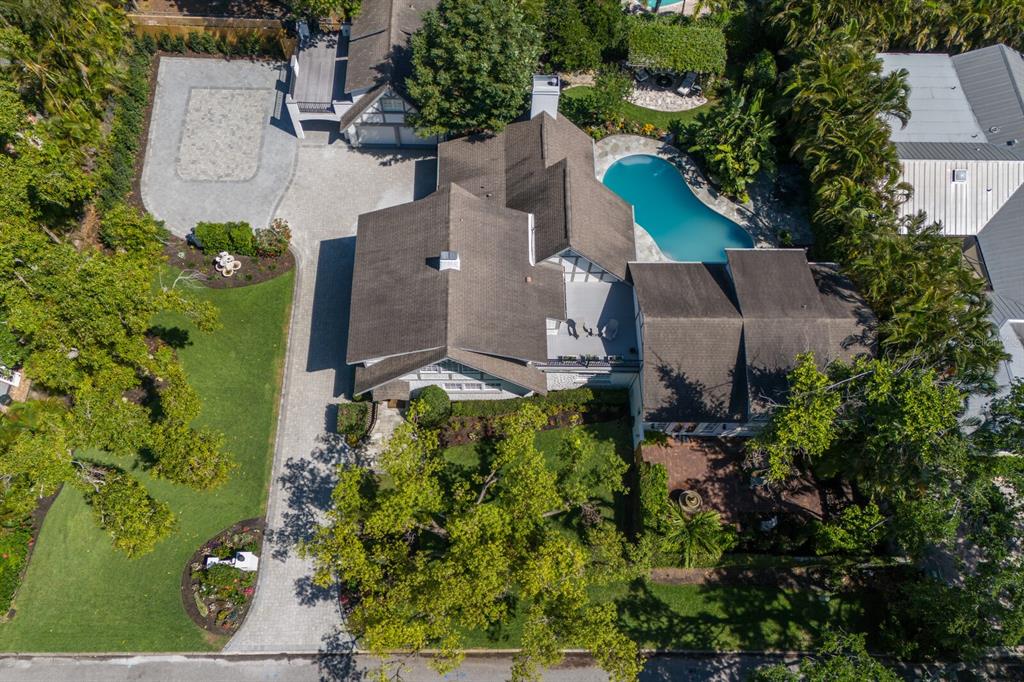 An aerial view shows a house with a shingled roof, swimming pool, and paved driveway — 1829 BOUGAINVILLEA STREET, SARASOTA, FL