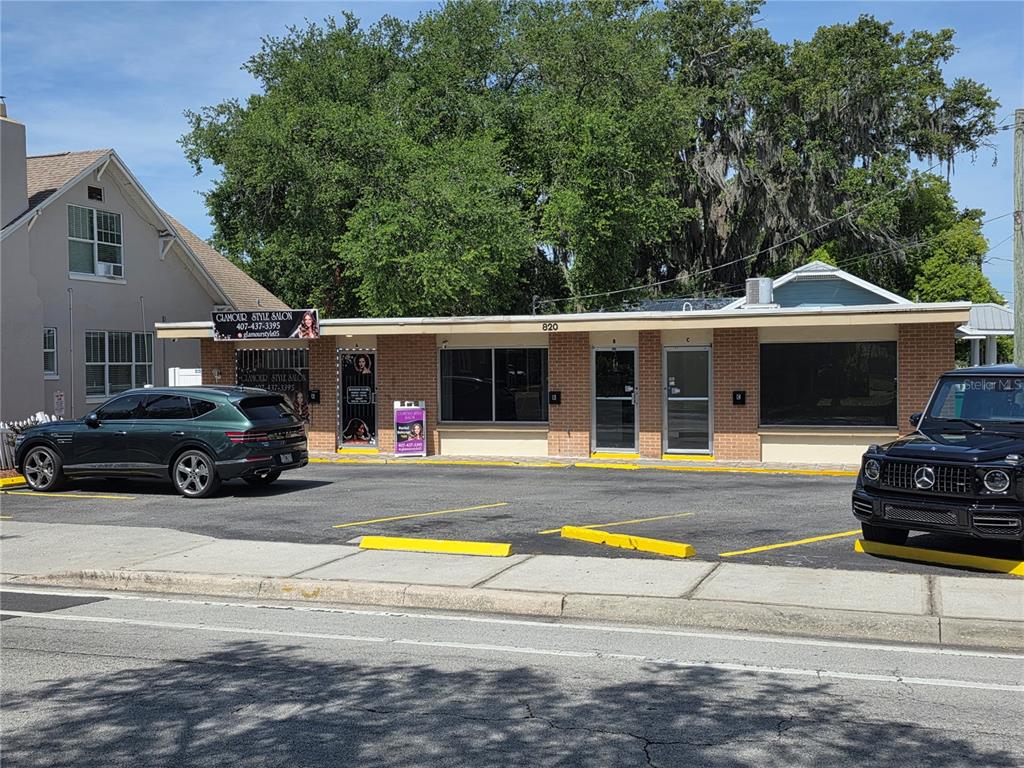 A single-story commercial building with brick facade and a parking lot in front — 820 N MAIN STREET, KISSIMMEE, FL