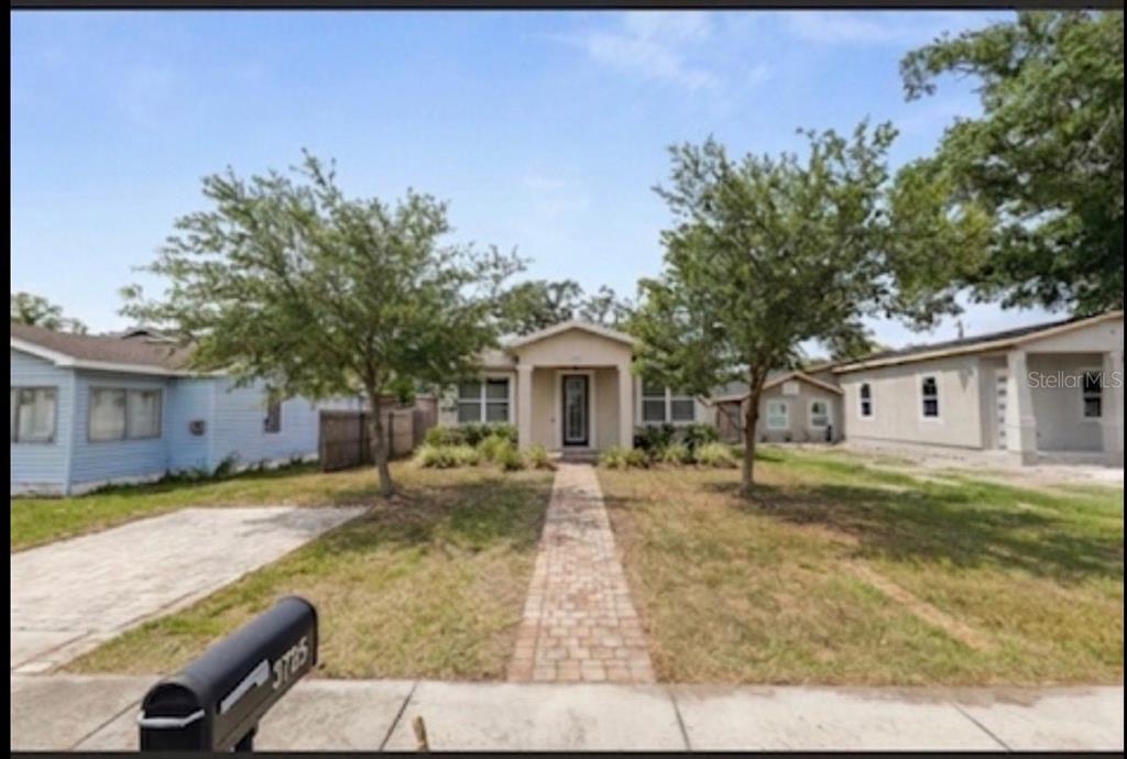 A single-story house with a brick walkway, two trees, and a mailbox in the front yard — 3725 57TH AVENUE N, ST PETERSBURG, FL