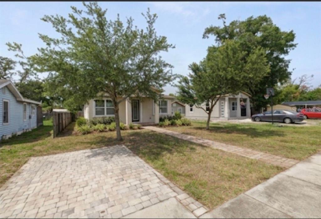 A single-story house with a paved driveway, a front walkway, and mature trees in front — 3725 57TH AVENUE N, ST PETERSBURG, FL