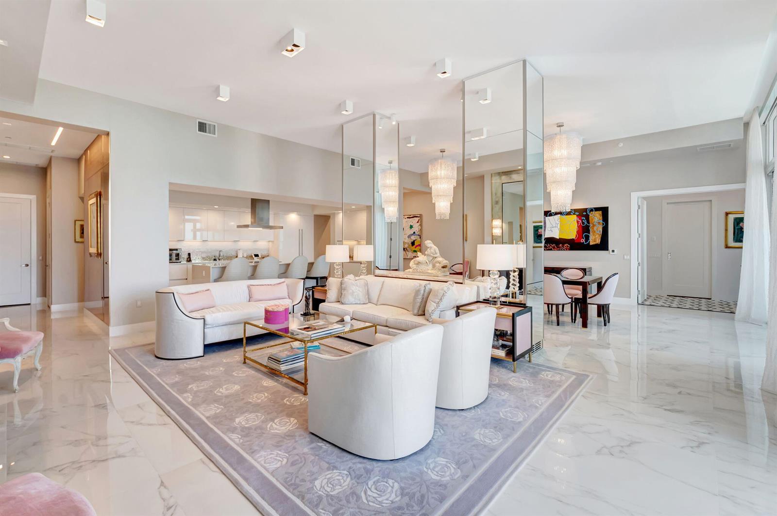 A modern living room with white furniture, a patterned area rug, and mirrored room dividers — 20155 Boca West Drive # c902, Boca Raton FL 33434, BOCA RATON, FL