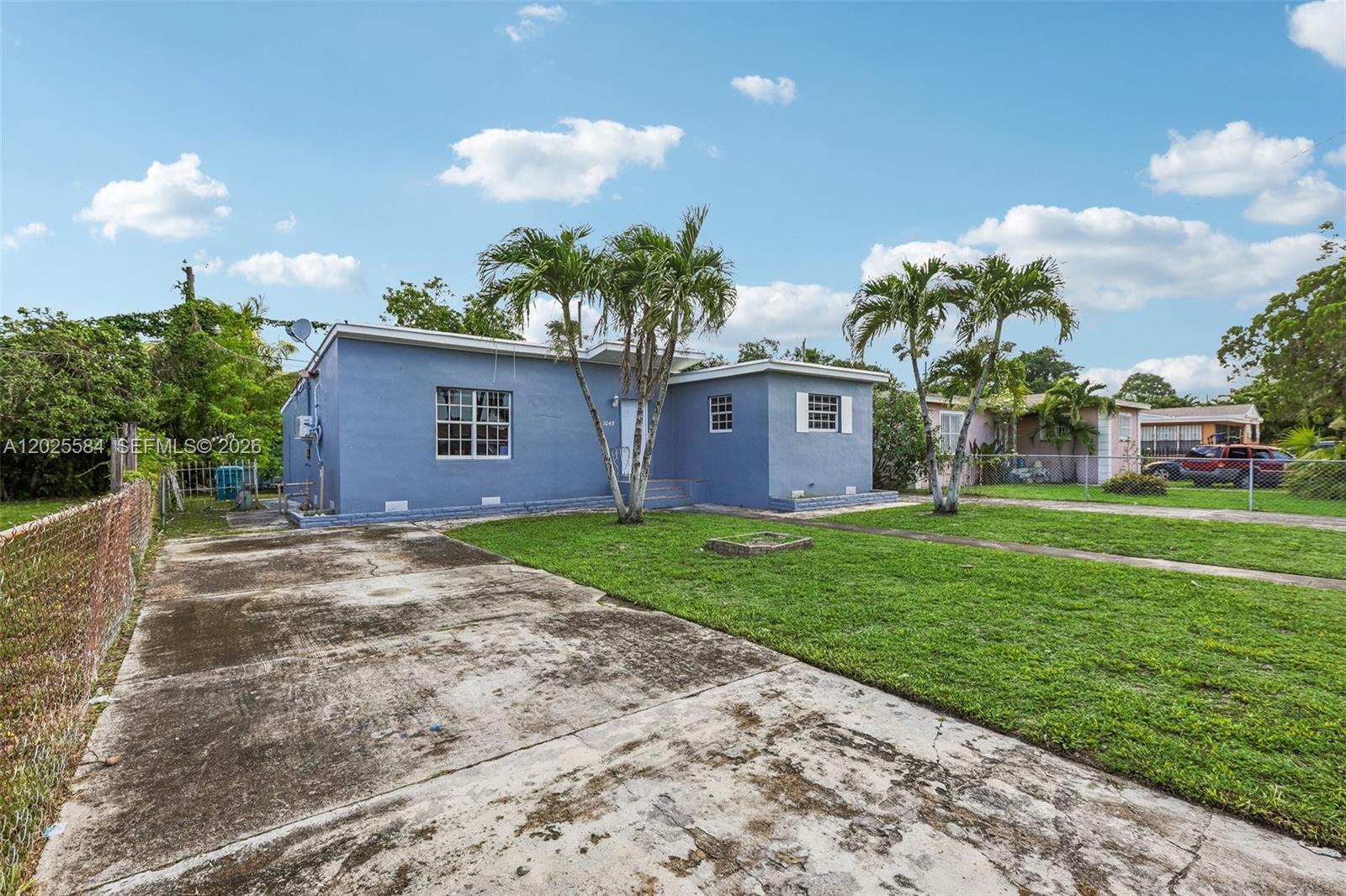 A narrow hallway features white walls, wood-look flooring, and two ceiling-mounted light fixtures — 1045 NW 115th St, Miami FL 33168, MIAMI, FL