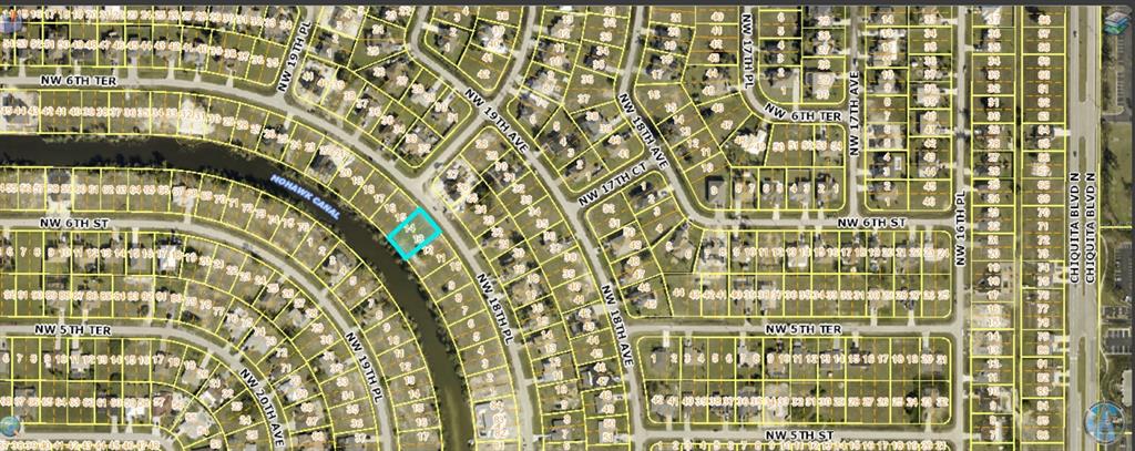 This is a satellite map showing a highlighted residential lot along a canal — 530 NW 18TH PLACE, CAPE CORAL, FL