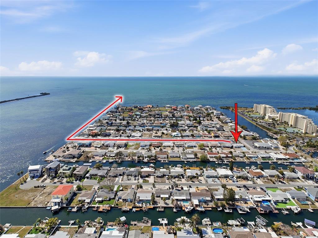 Aerial view of a coastal neighborhood with canals and houses near the ocean — 13701 VERONICA DRIVE, HUDSON, FL