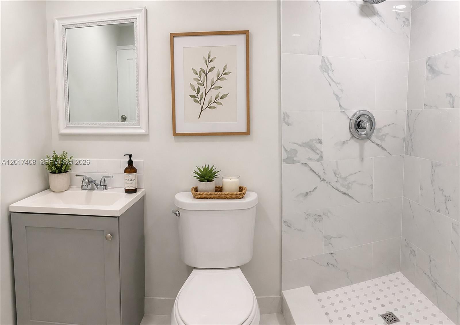 A bathroom features a gray vanity, white toilet, and a walk-in shower with marble-look tiles — 14830 Naranja Lakes Blvd, Miami FL 33032, MIAMI, FL