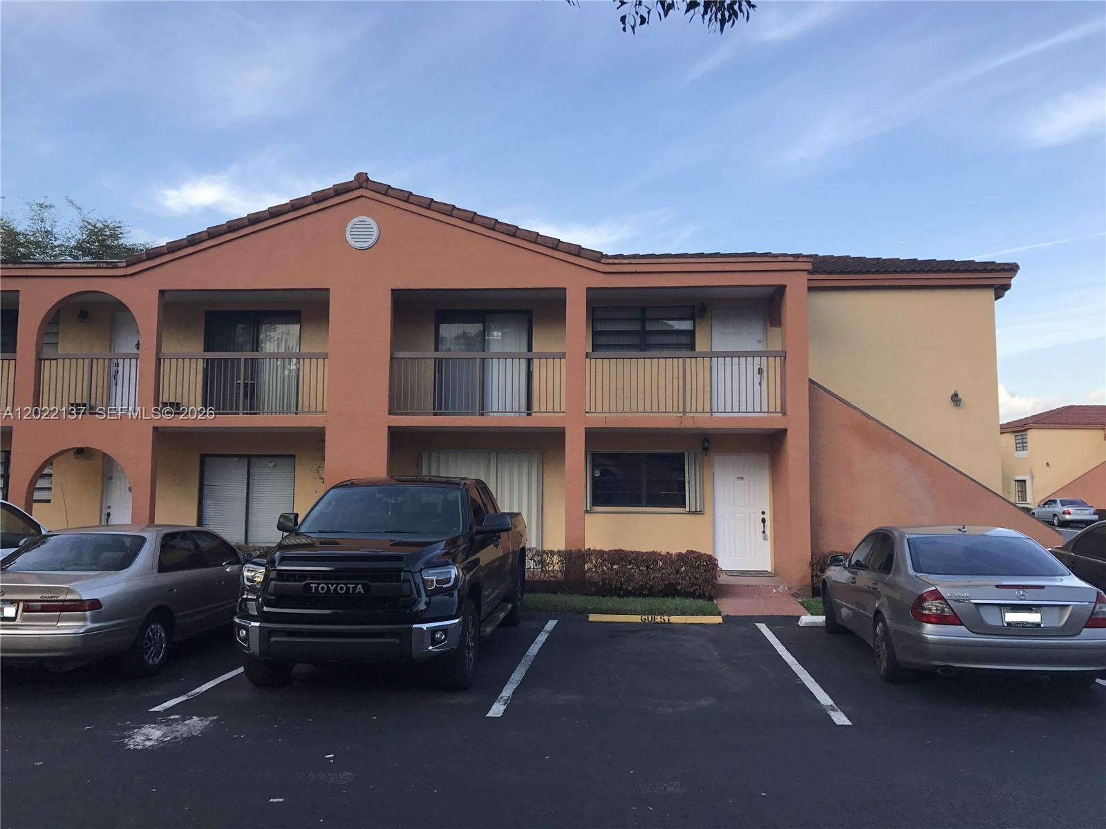 A two-story apartment building with a parking lot in front and a guest space — 18224 Mediterranean Blvd # 17, Miami FL 33015, MIAMI, FL