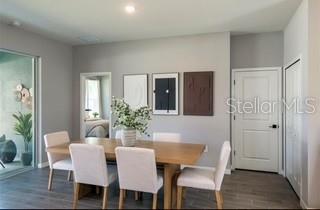 A dining room features a wooden table, six chairs, and three framed wall art pieces — 8719 SW 139TH PLACE, OCALA, FL