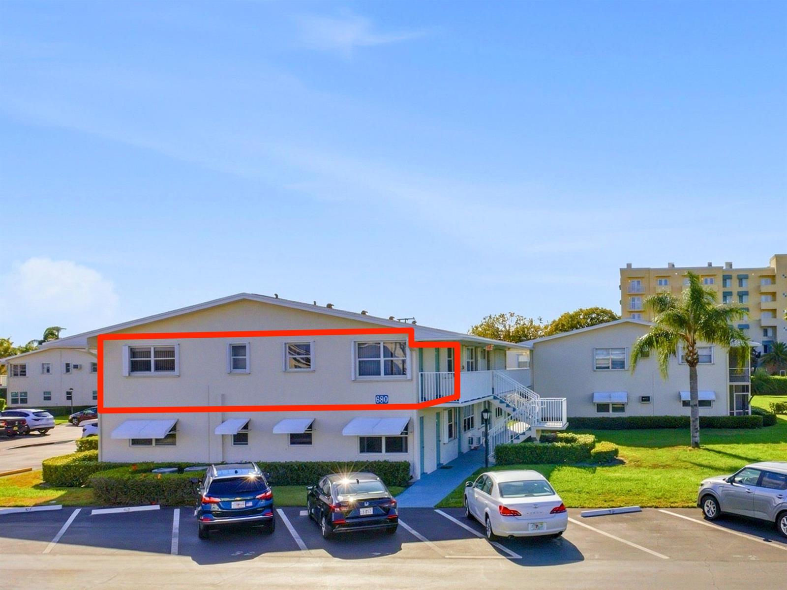 An exterior view of a two-story apartment building with a red outline highlighting the unit — 680 W Horizons # 212, Boynton Beach FL 33435, BOYNTON BEACH, FL