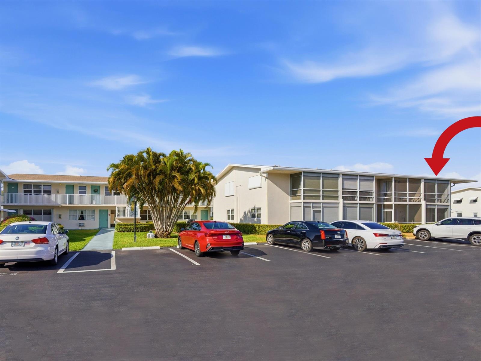 An exterior view of a two-story apartment building with a parking lot in front — 680 W Horizons # 212, Boynton Beach FL 33435, BOYNTON BEACH, FL