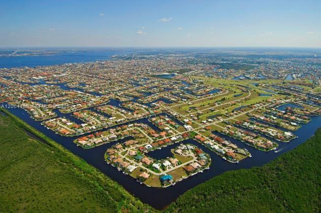 An aerial view of a residential neighborhood with houses situated along winding canals — 2356 Highland, Punta Gorda FL 33983, PUNTA GORDA, FL