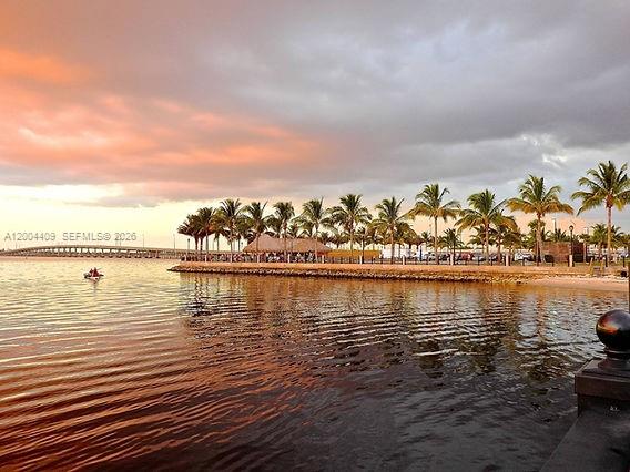 A waterfront view of a palm-lined park at sunset with a bridge in the distance — 2356 Highland, Punta Gorda FL 33983, PUNTA GORDA, FL