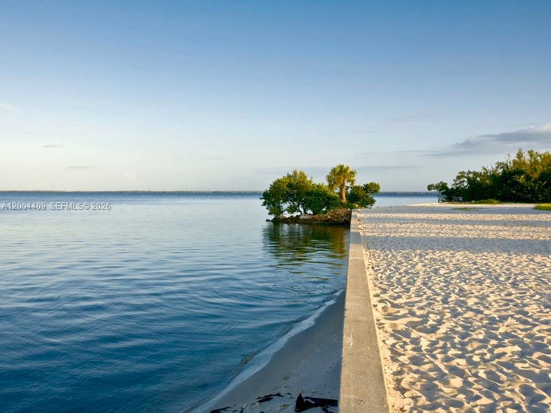 A concrete seawall separates a sandy beach from the calm water of a bay — 2356 Highland, Punta Gorda FL 33983, PUNTA GORDA, FL