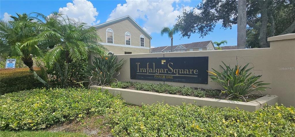 A sign for Trafalgar Square Phase One stands in front of a tan apartment building — 4337 DEERMONT CIRCLE, TAMPA, FL