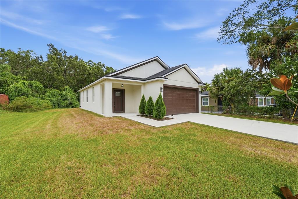A single-story house with a white exterior, brown garage door, and a front lawn — 5401 OLD CHENEY HIGHWAY, ORLANDO, FL