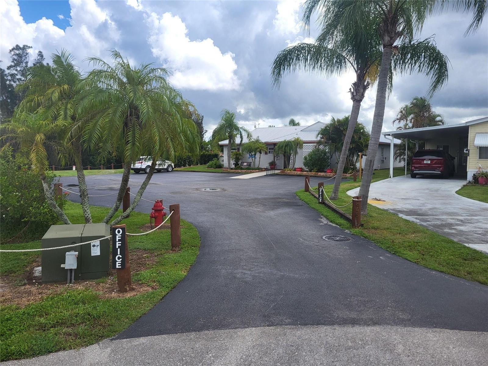 A paved driveway leads toward a building with palm trees and a red fire hydrant — 803 & 805 & 805 Big Branch Lane, Moore Haven FL 33471, MOORE HAVEN, FL