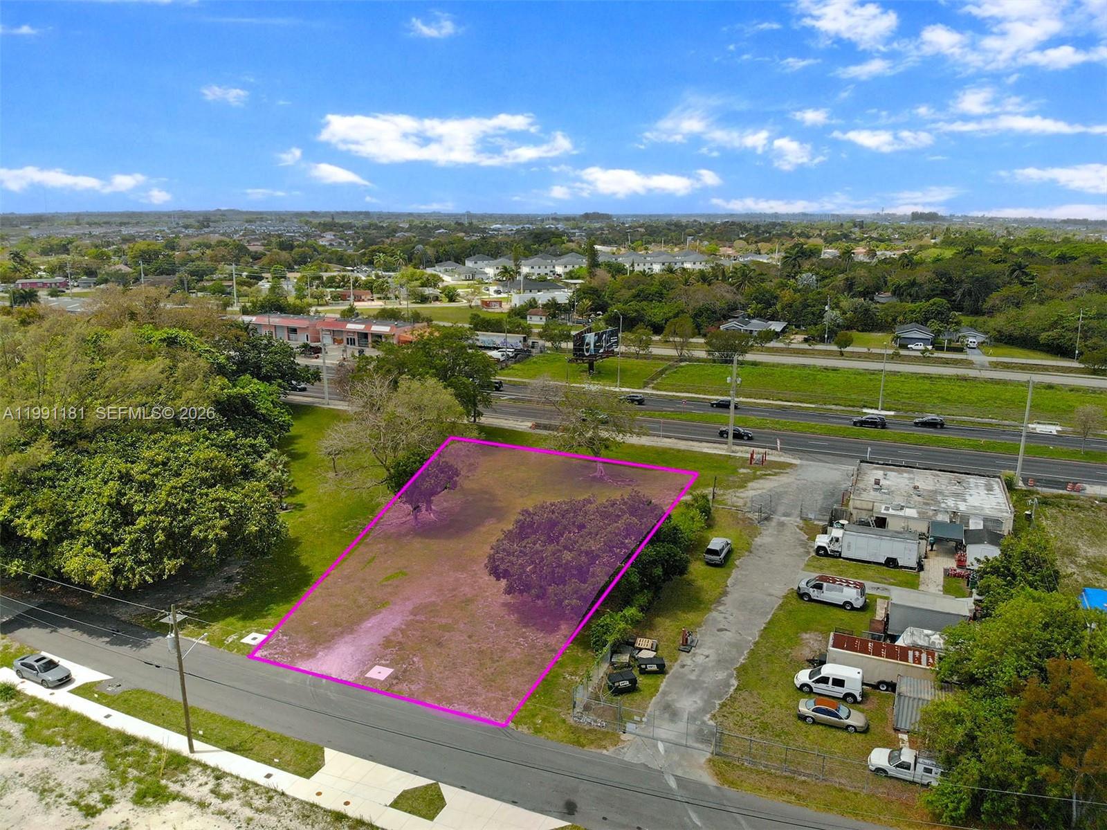 An aerial view shows a vacant, rectangular lot outlined in pink next to a road — 22650 SW 123rd Rd, Miami FL 33170, MIAMI, FL