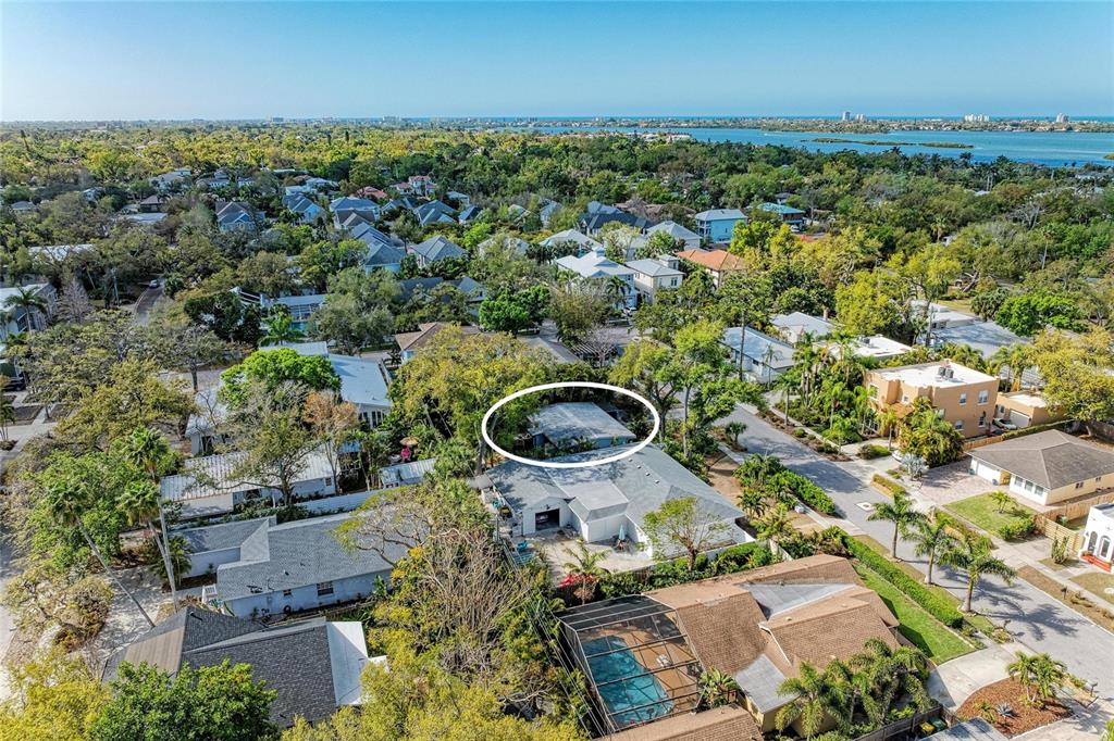 An aerial view shows a residential neighborhood with a circled house surrounded by lush trees — 3625 JACINTO COURT, SARASOTA, FL