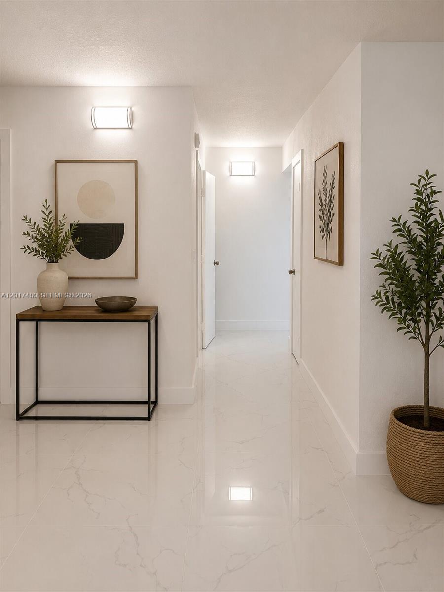 A bright hallway features white marble-look tile flooring, a wooden console table, and potted plants — 14830 Naranja Lakes Blvd, Homestead FL 33032, HOMESTEAD, FL
