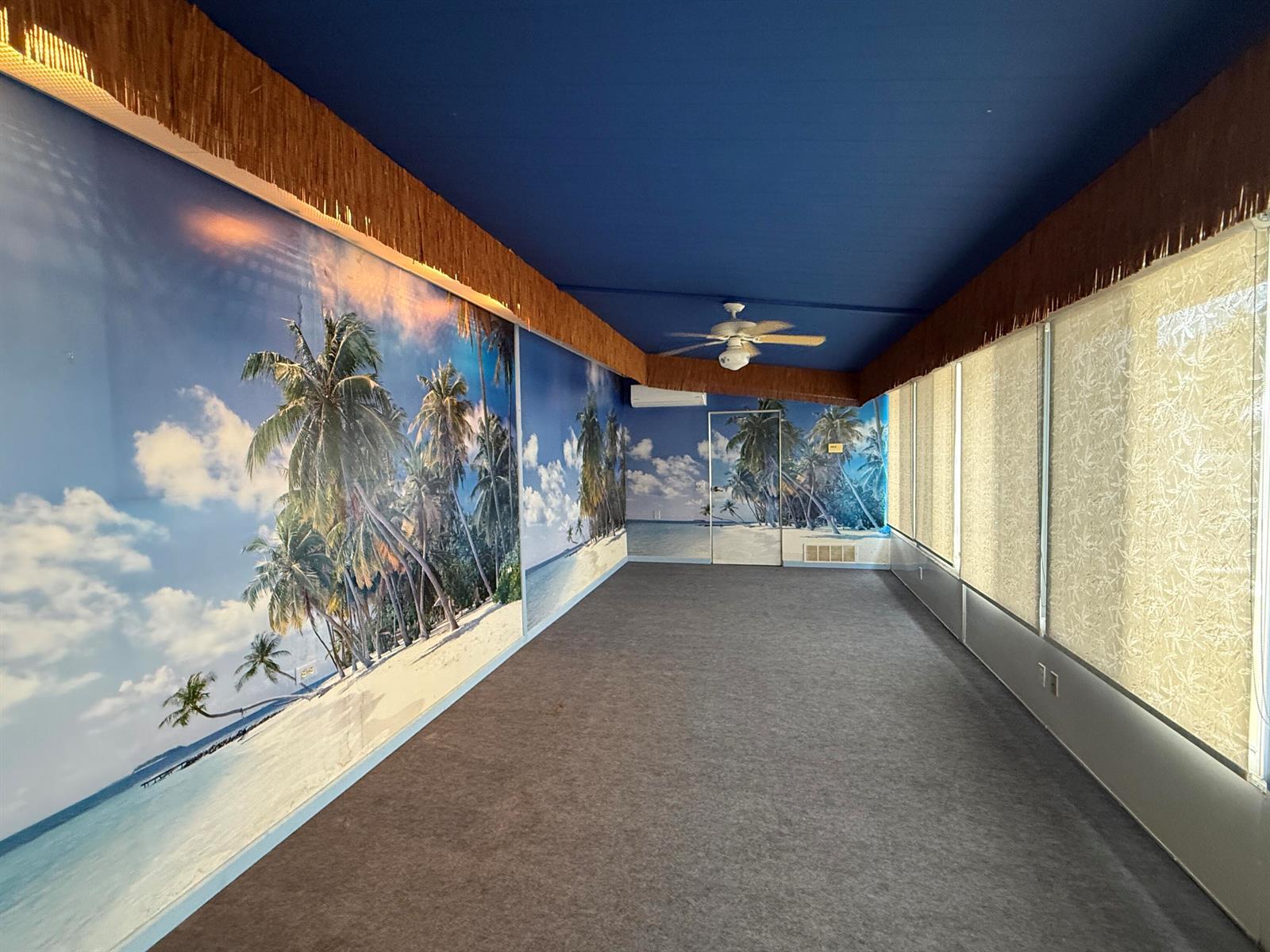 A long room features a tropical beach mural, blue ceiling, and brown fringe trim — 7089 SE Bluebird Circle, Hobe Sound FL 33455, HOBE SOUND, FL
