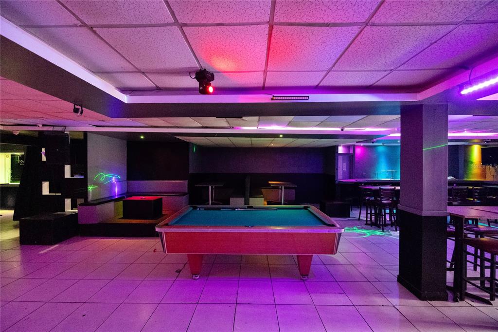 A pool table sits in the center of a room with tiled floors and purple lighting — 239 C ELEANOR ROOSEVELT, SAN JUAN, PR