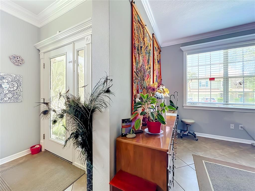 A room features a red accent wall, a ceiling fan, and a desk with a chair — 2379 PICKFORD CIRCLE, APOPKA, FL